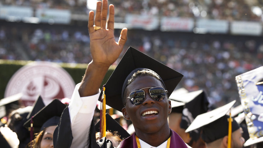  Mark Boster / Los Angeles Times  Galaxy soccer star Gyasi Zardes waves to his family during the graduation ceremony at Cal State Dominguez Hills on May 19. 