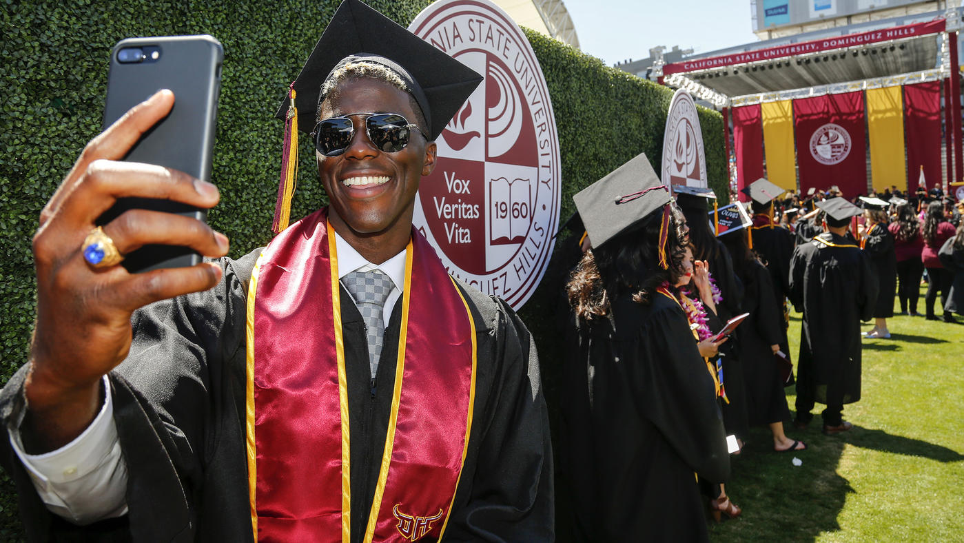  Mark Boster / Los Angeles Times  Gyasi Zardes snaps a selfie of himself while waiting with other graduates at Cal State Dominguez Hills' commencement ceremony at StubHub Center, where he stars for the L.A. Galaxy. 