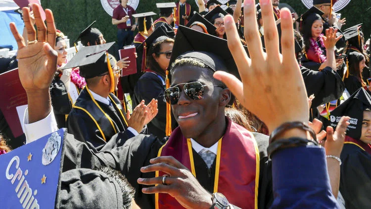 Gyasi Zardes celebrates with fellow Cal State Dominguez Hills graduates during their graduation ceremony. (Mark Boster / Los Angeles Times)