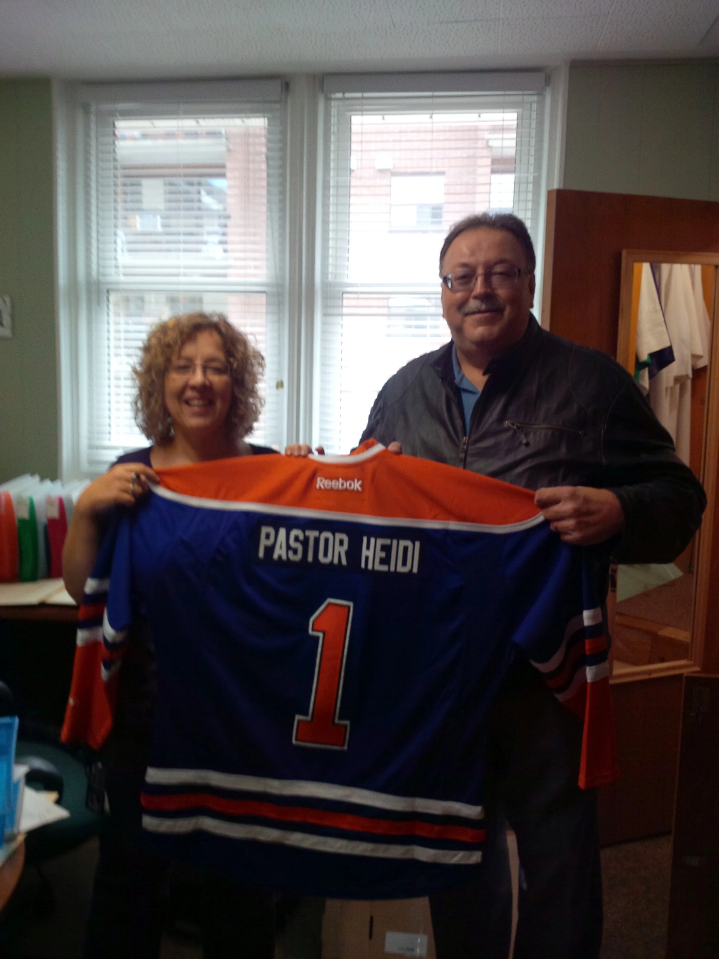 Karl Kiefer, a member of the church council, presented Pastor Heidi with her very own Edmonton Oilers jersey with her name stitched on it.