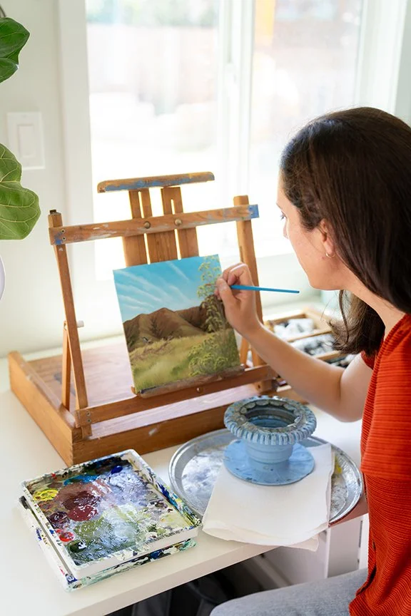 Kristen Walker, Santa Barbara artist, painting a small acrylic landscape of Santa Cruz Island in her art studio. Fine art inspired by California's Channel Islands, native landscapes, and conservation.