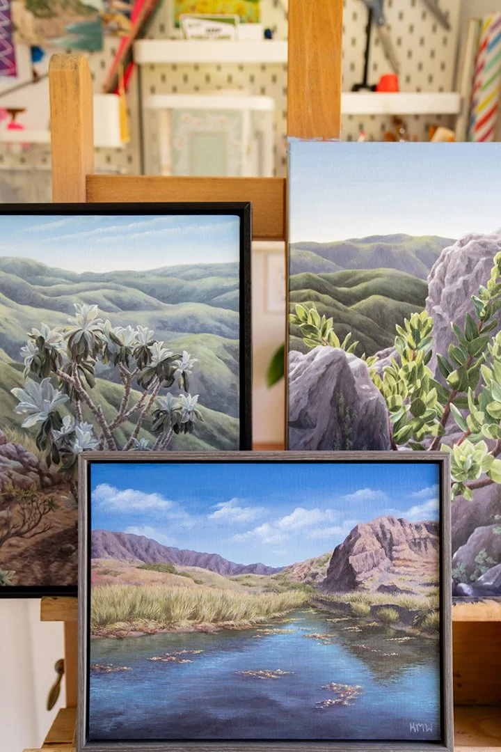 Three original acrylic paintings of Santa Cruz Island displayed on an easel in artist Kristen Walker's Santa Barbara studio, featuring California native plants and island landscapes.