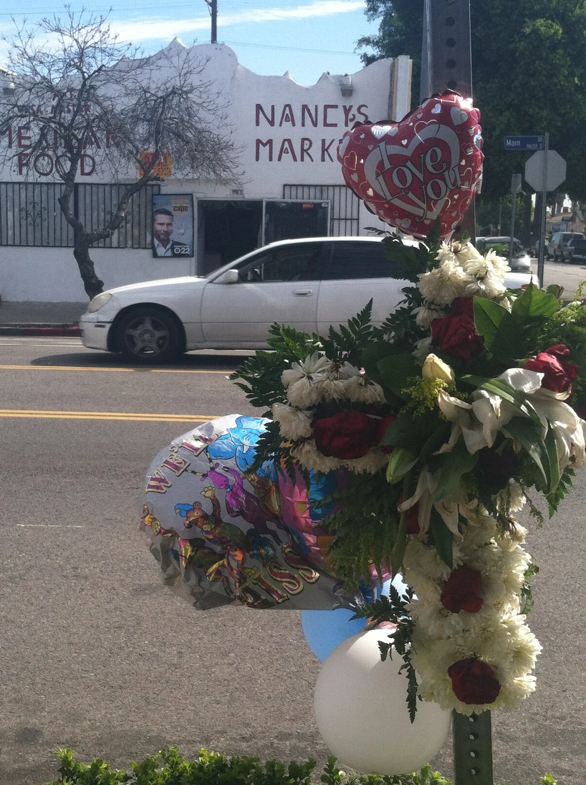 Street memorial for Douglas Wooley who was shot to death on March 6 at 97th and Main Street. Wooley, a sickle-cell anemia sufferer, was listening to music with earphones when he was gunned to the ground.