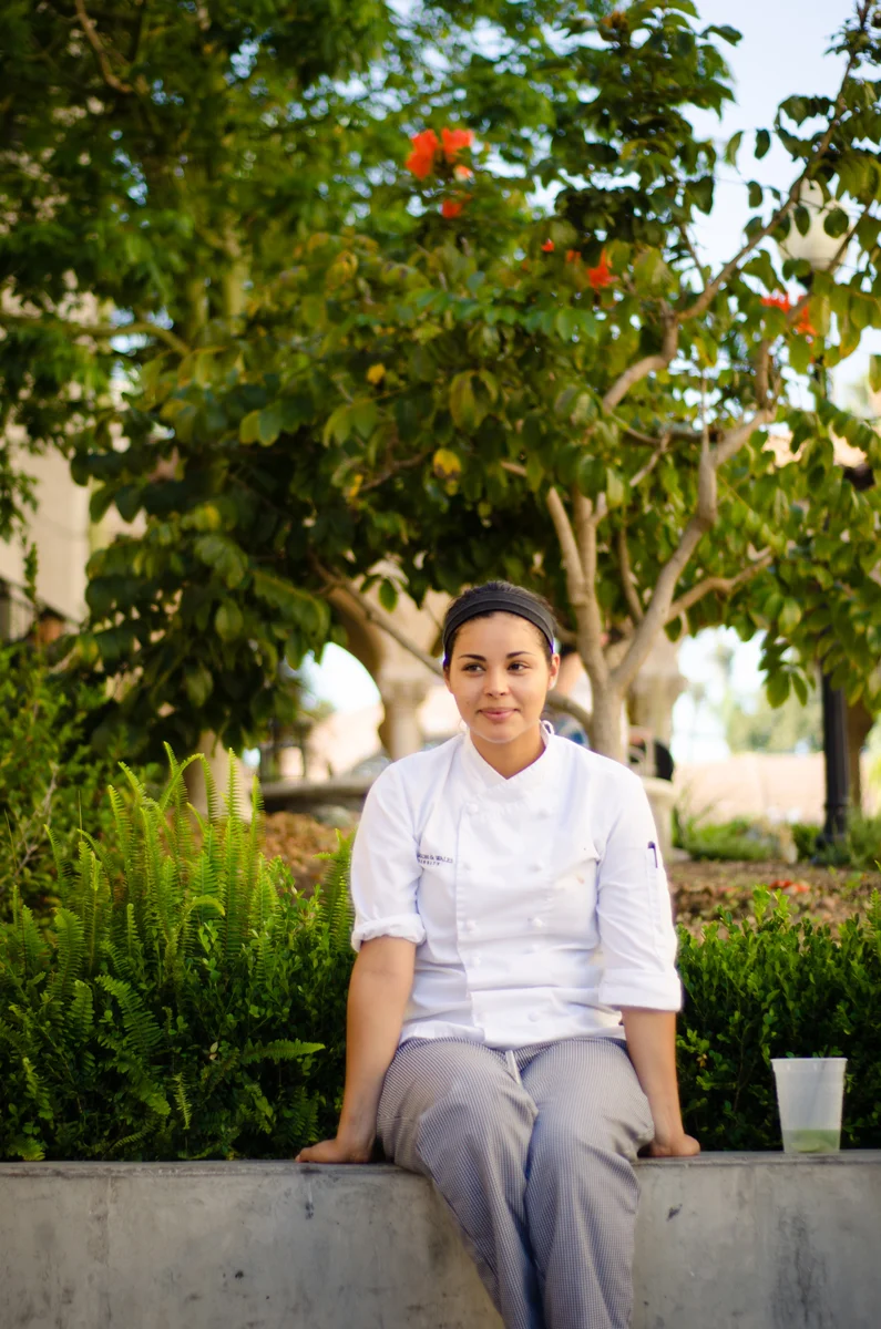 Gema, part of the cooking staff at The Prado, takes a break before heading back to work the first of three weddings scheduled on a typical Saturday for the restaurant. San Diego, 2013
