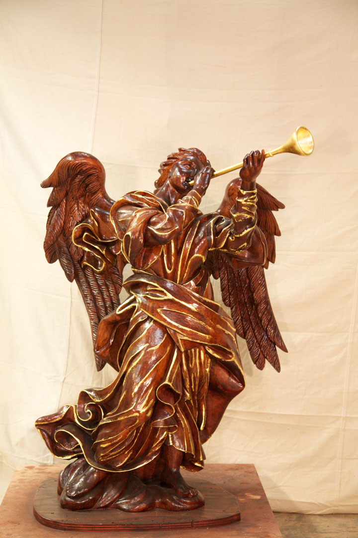 Hand carved angel with trumpet.