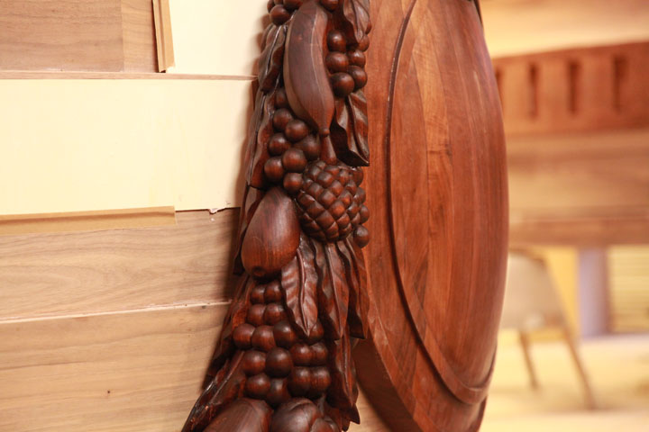 Detail of hand carved walnut swag and shield before gilding. 