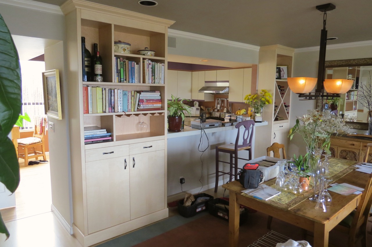 Completed cabinets in figured Maple, built floor to ceiling with matched crown moldings.