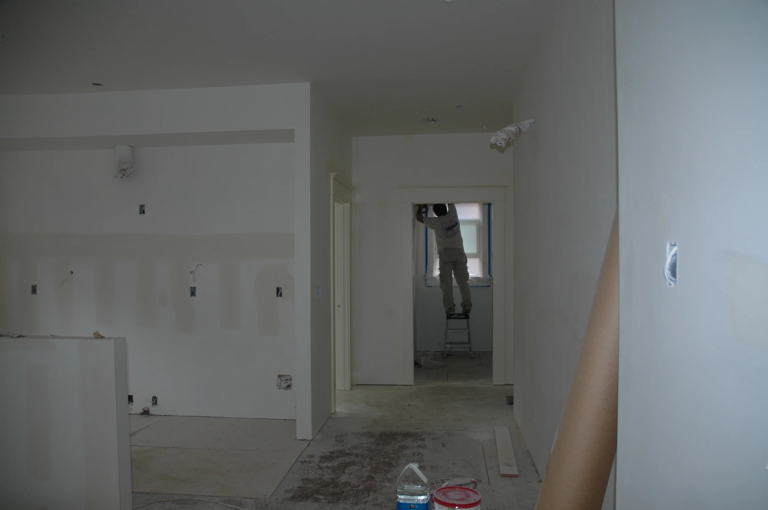 Masking off the window in the bathroom of the Sellwood