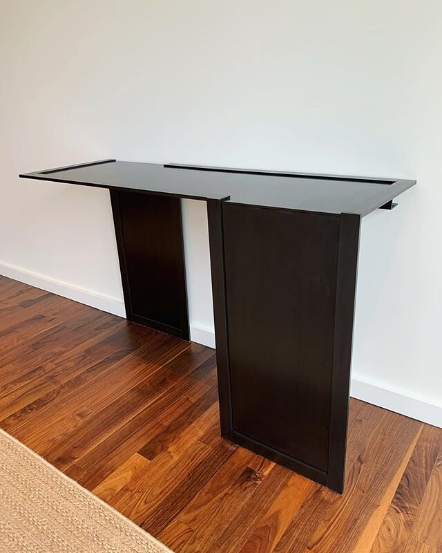 A sleek blackened steel console table for @gambleplusdesign