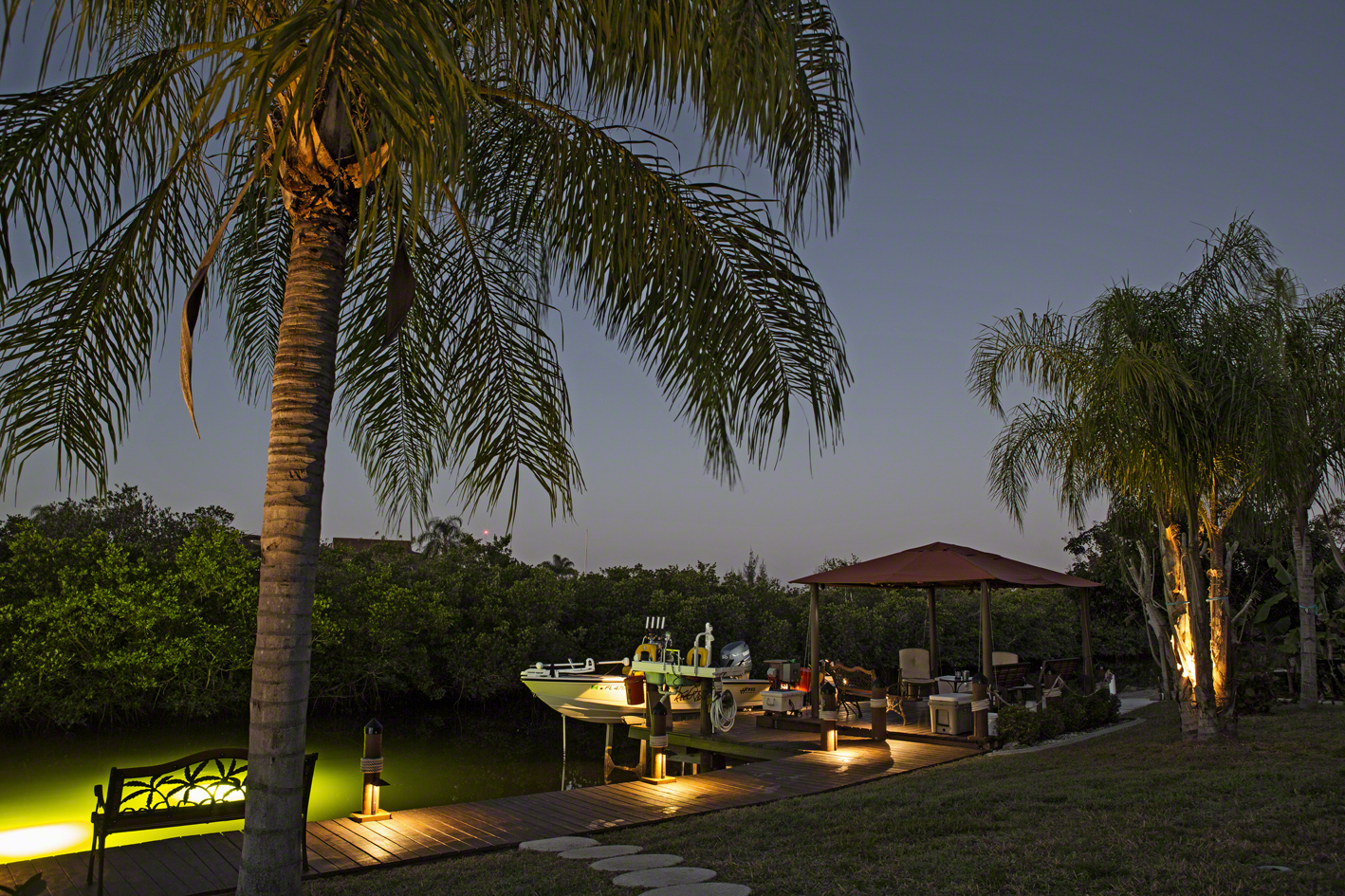 the back yard, complete with canal, dock, gazebo and boat. you know you've made it when your landscaping is this well lit. 