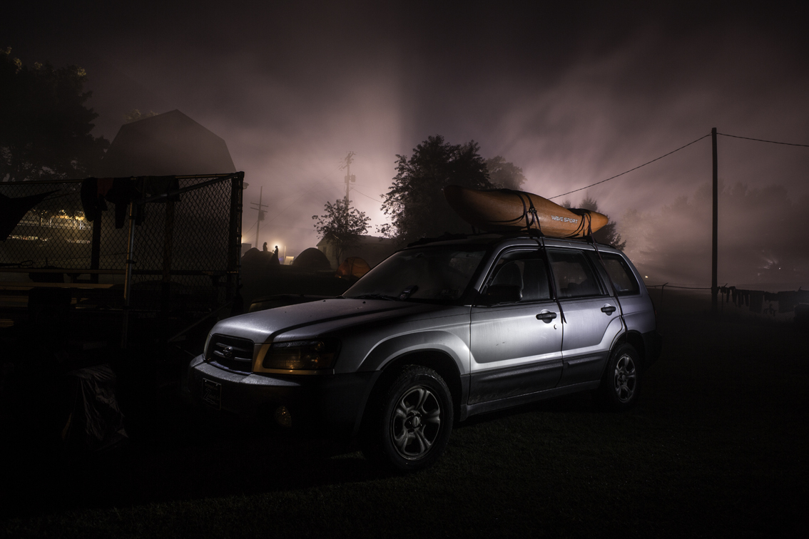 dish glove dave's subaru on a foggy night - the festival is raging beyond the barn under the stadium lights