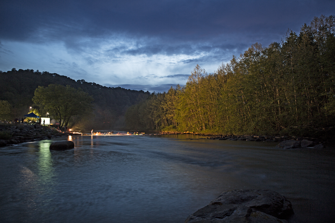 A light illuminates the paddlers on the play wave at the Stonycreek Rendezvous, in PA.