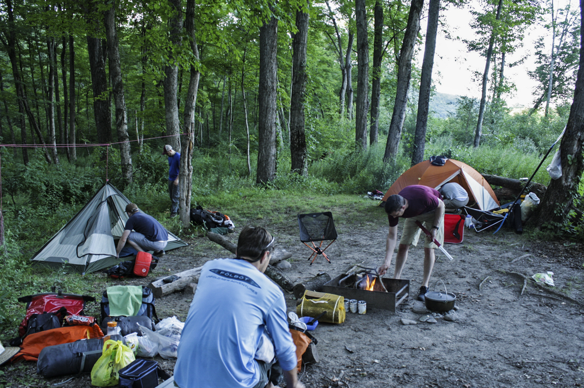 Camp night one. Dave (far left) forgot his tent poles, so he engineered the "ground hammock" 1.0. by tying a rope between the trees and then attaching the top of his tent to it.