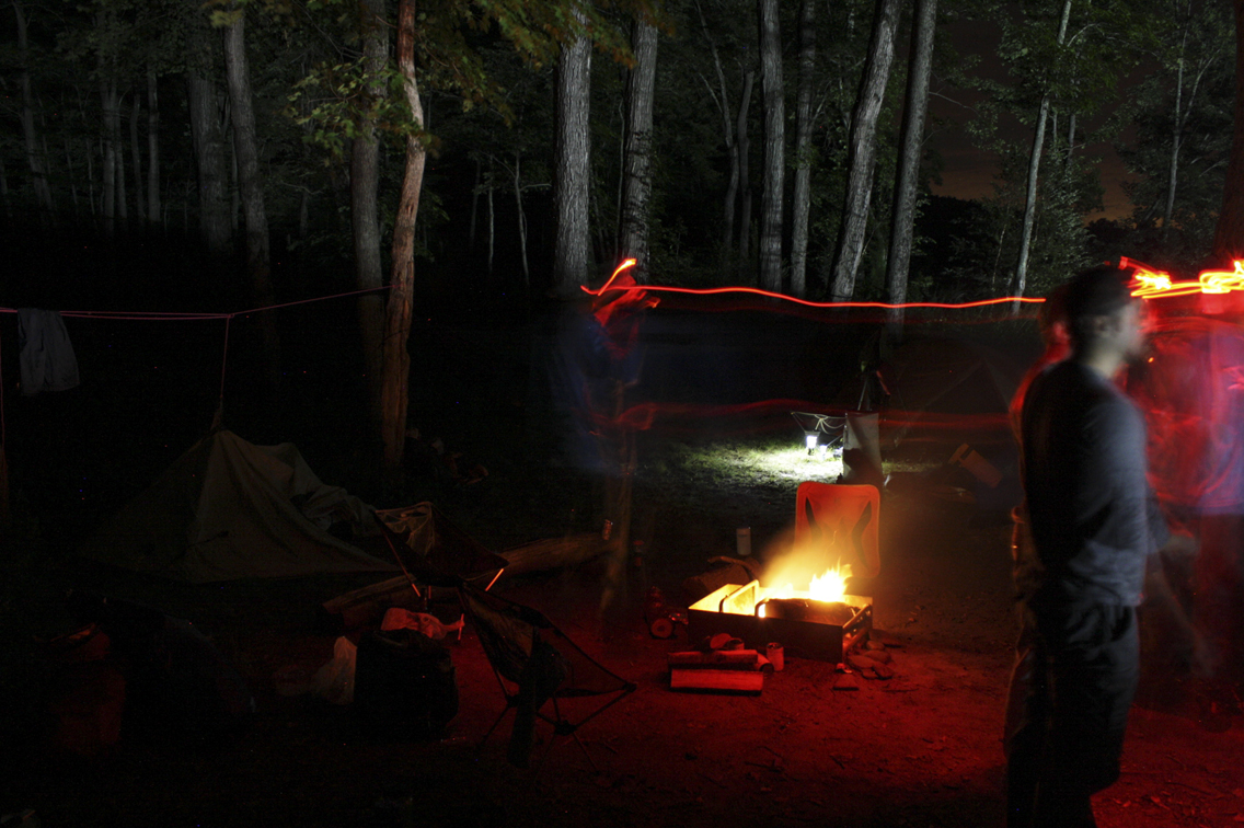 A spot light illuminating the trees above our campsite.
