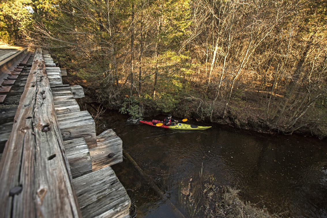 Loren navigating under an old train trestle on the first few miles of the Batsto. 