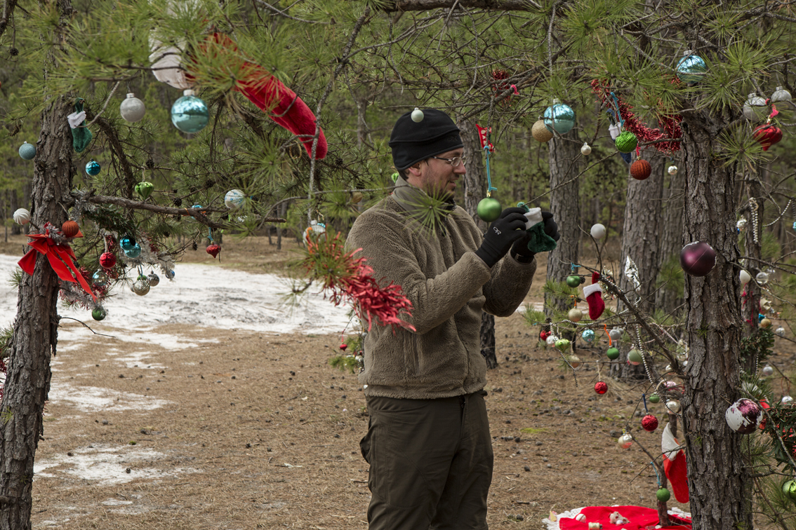 We found this section of pines that were decorated for Christmas, and Frank got to work re-decorating with ornaments that had blown off. 