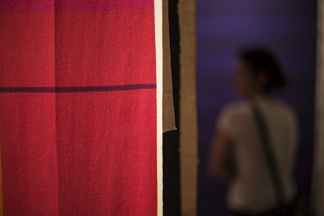 Sloane among the many reams of fabric hanging in the Danish Design Museum.