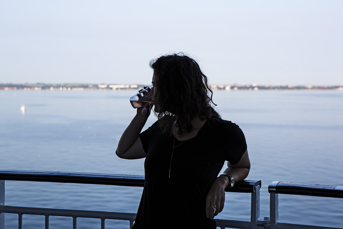 Sloane enjoying some wine while cruising up the Swedish coast.