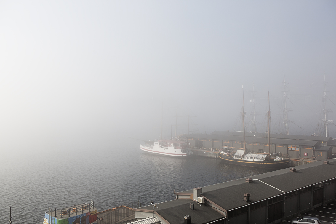 A foggy view of the small harbor from the walls of Akershus.