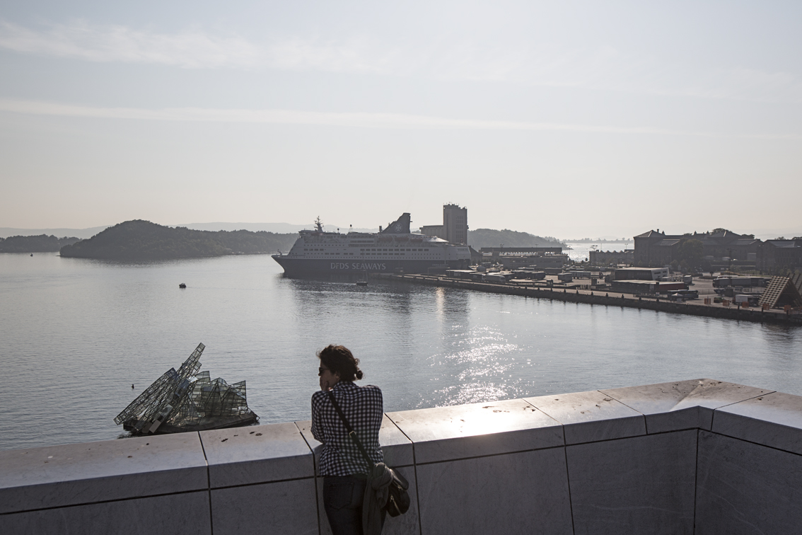 Sloane on top of the opera house roof, that Norwegian fog off in the distance. 