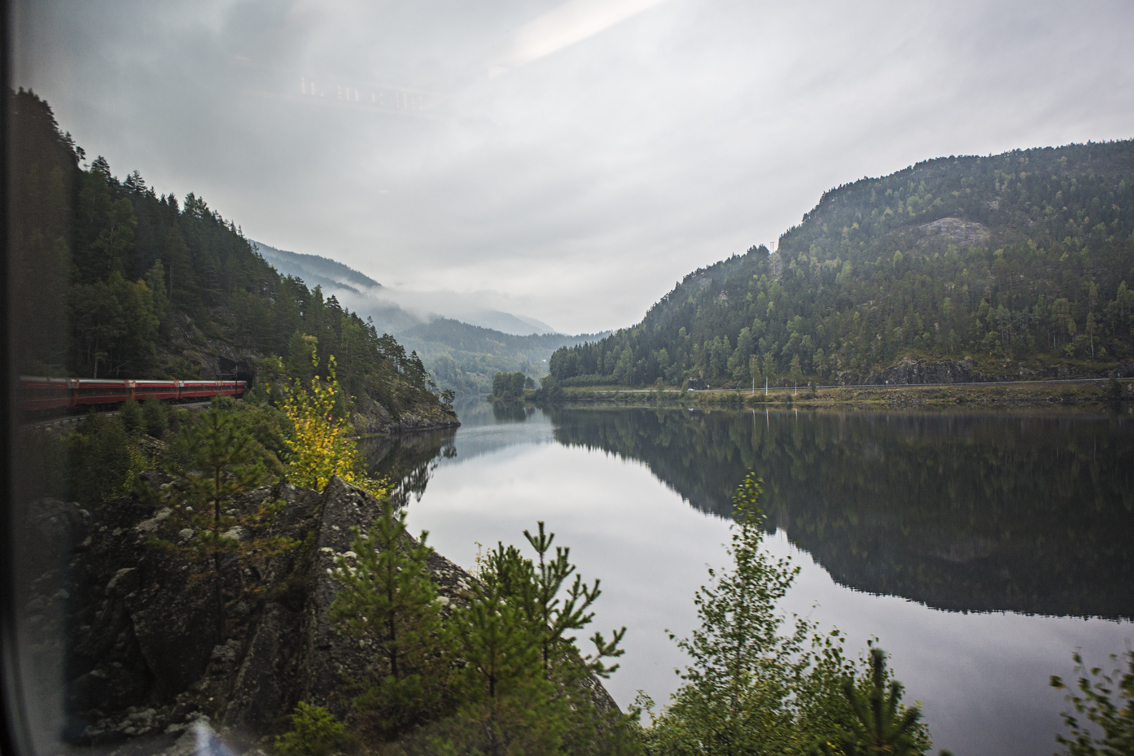 Our train coming out of a tunnel, passing a mountain lake en route to Voss.
