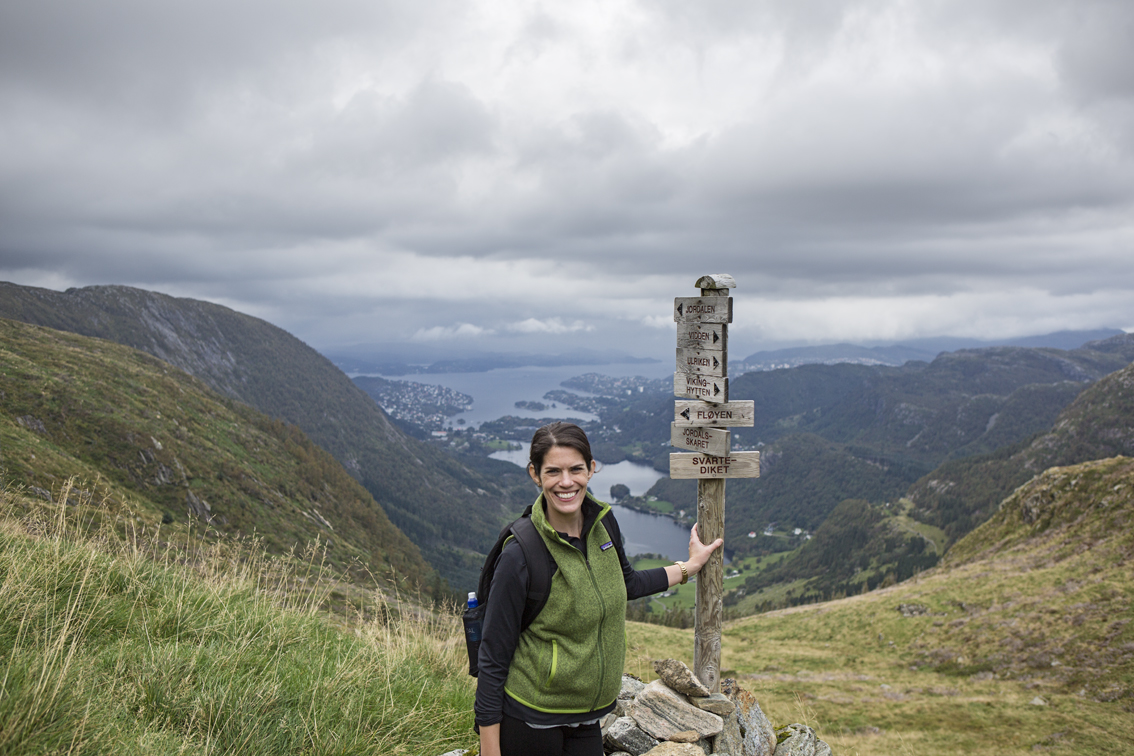 Sloane by one of the signposts marking the way. in the valley below is the town of Ervik, just outside of Bergen, and beyond that is the North Sea.