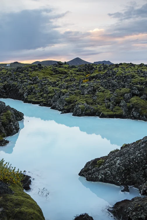 Blue lagoon water and epic iceland backdrop.