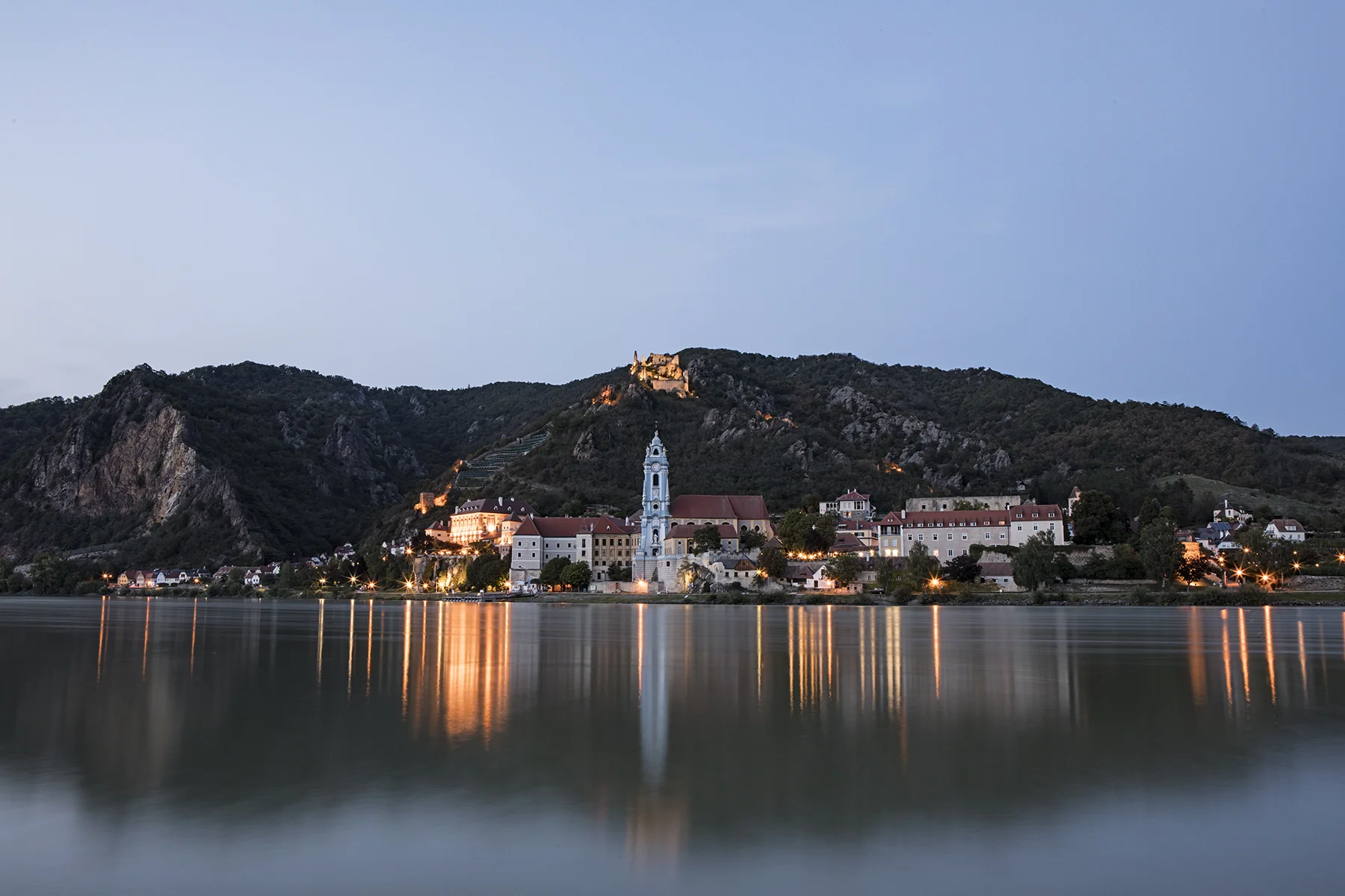Durnstein from across the Danube, There is a 12th century castle ruin that you can see lit in the middle of the frame - history lesson here .