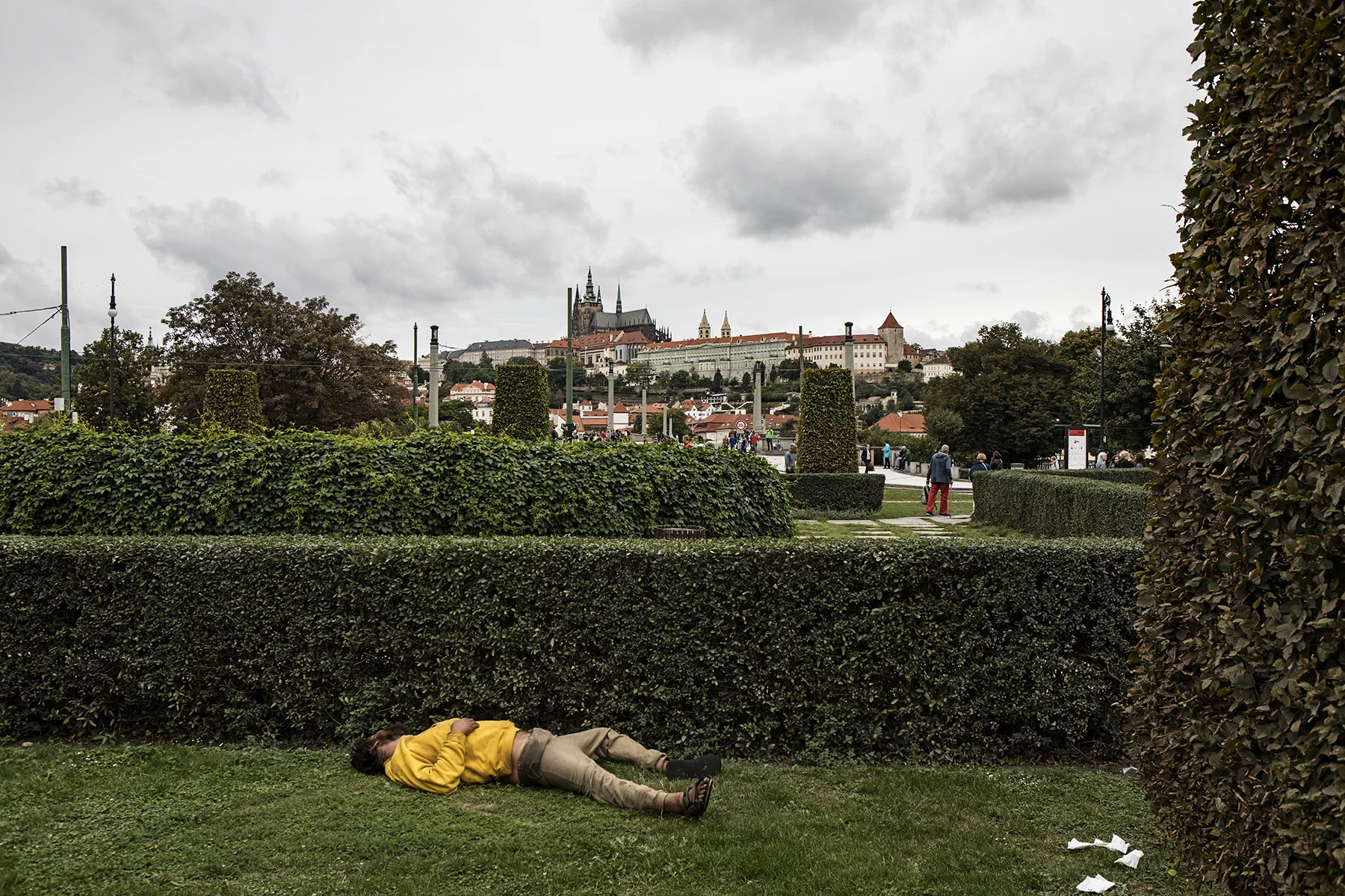 Highlight of the tour - this guy stole the show. Passed out in the middle of the afternoon - evidence suggests he may have taken a dump nearby, given the toilet paper strewn about. Prague Castle in the background.