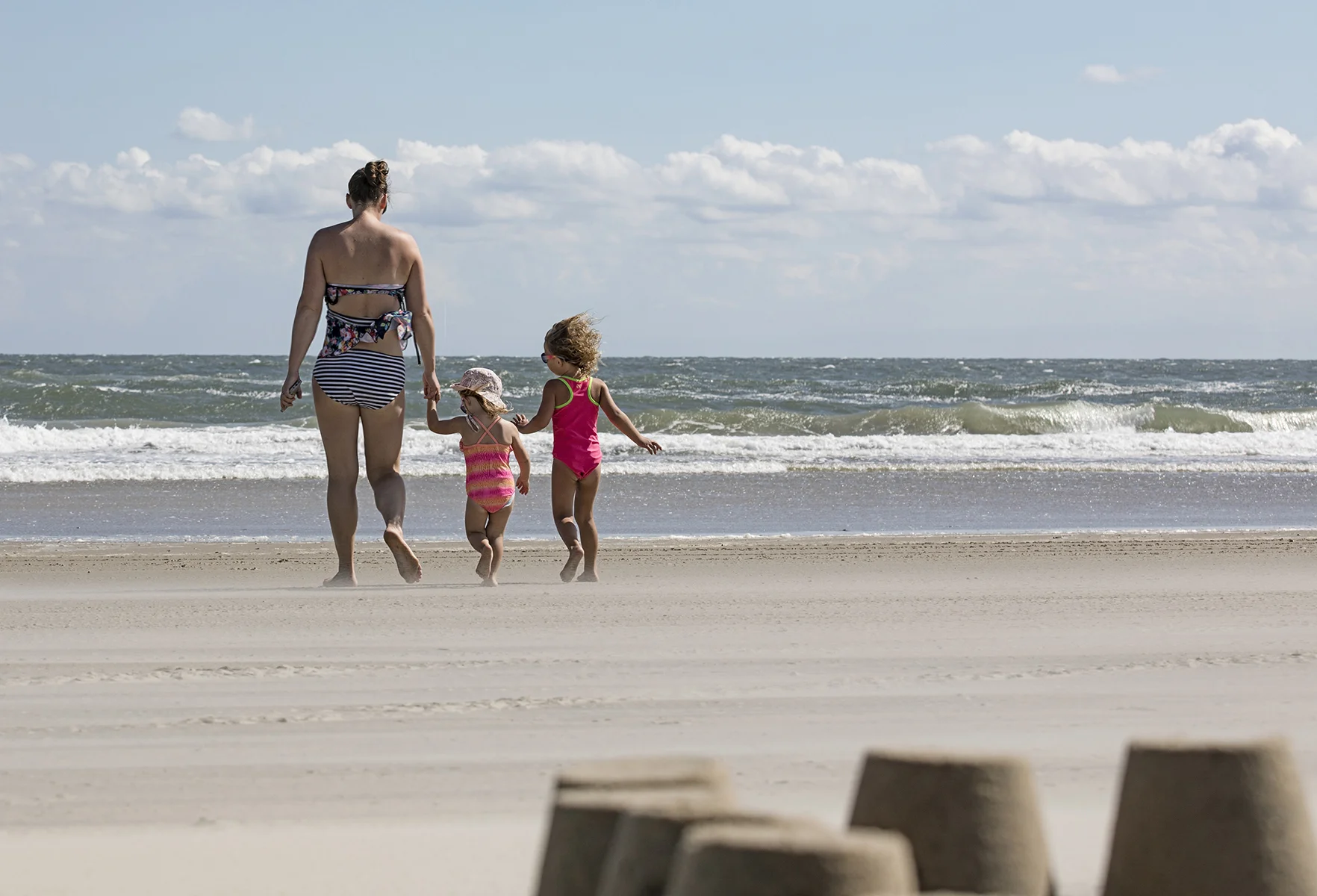 Dragging their mom back into the chilly water, which was made even colder by the wind.