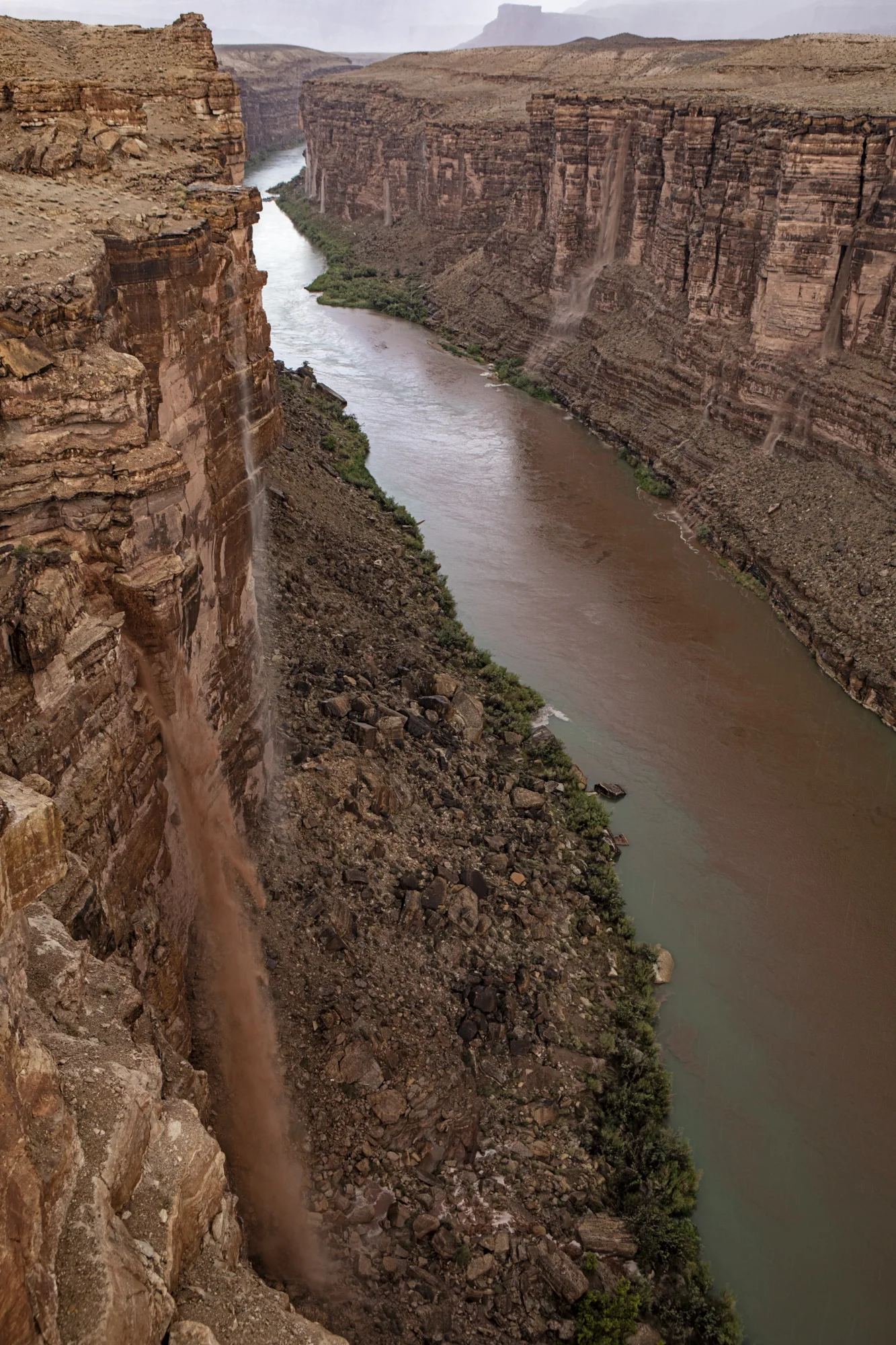 Waterfalls of mud falling down the canyon walls.