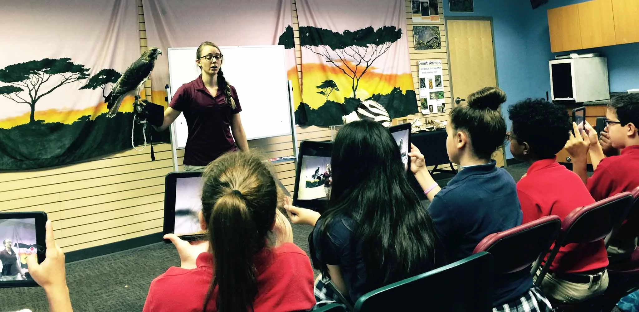 Sixth graders use iPads to take pictures and notes during a workshop at the Memphis Zoo.