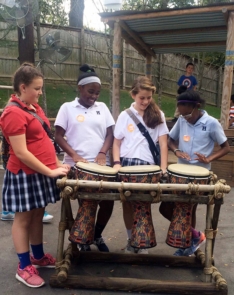 Bella, Skyler, Lauren, and Shelby try their hand at the bongos.