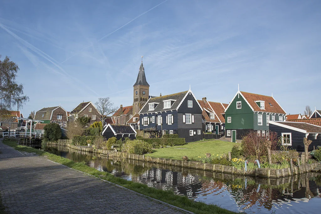 Characteristic wooden houses, a canal, and the town church in the background, Marken, NL. Photo: Harm Joris ten Napel
