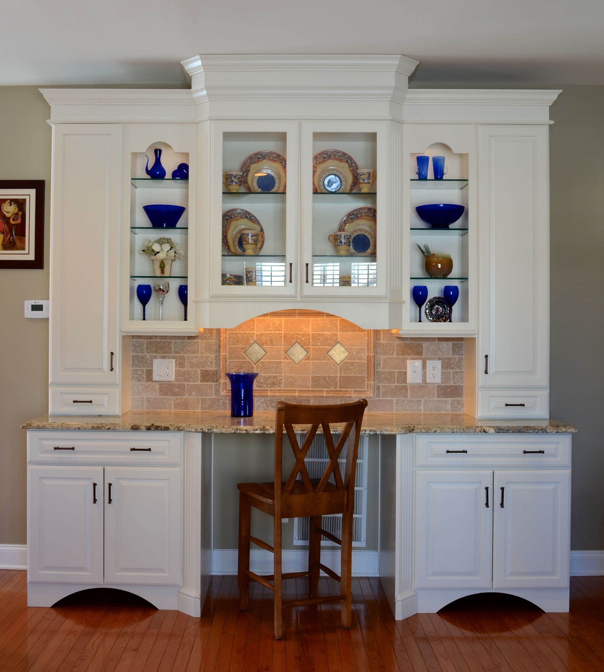 We used stock cabinetry to crate this free standing, multi-purpose hutch to look like a custom piece of furniture