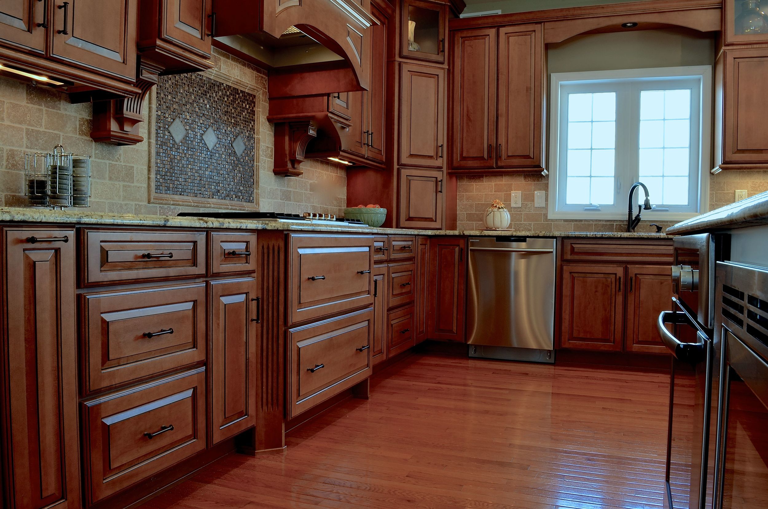 This warm, inviting yet elegant kitchen / great room combines a gourmet kitchen with a dining area for 10, an integrated desk and buffet with china display.