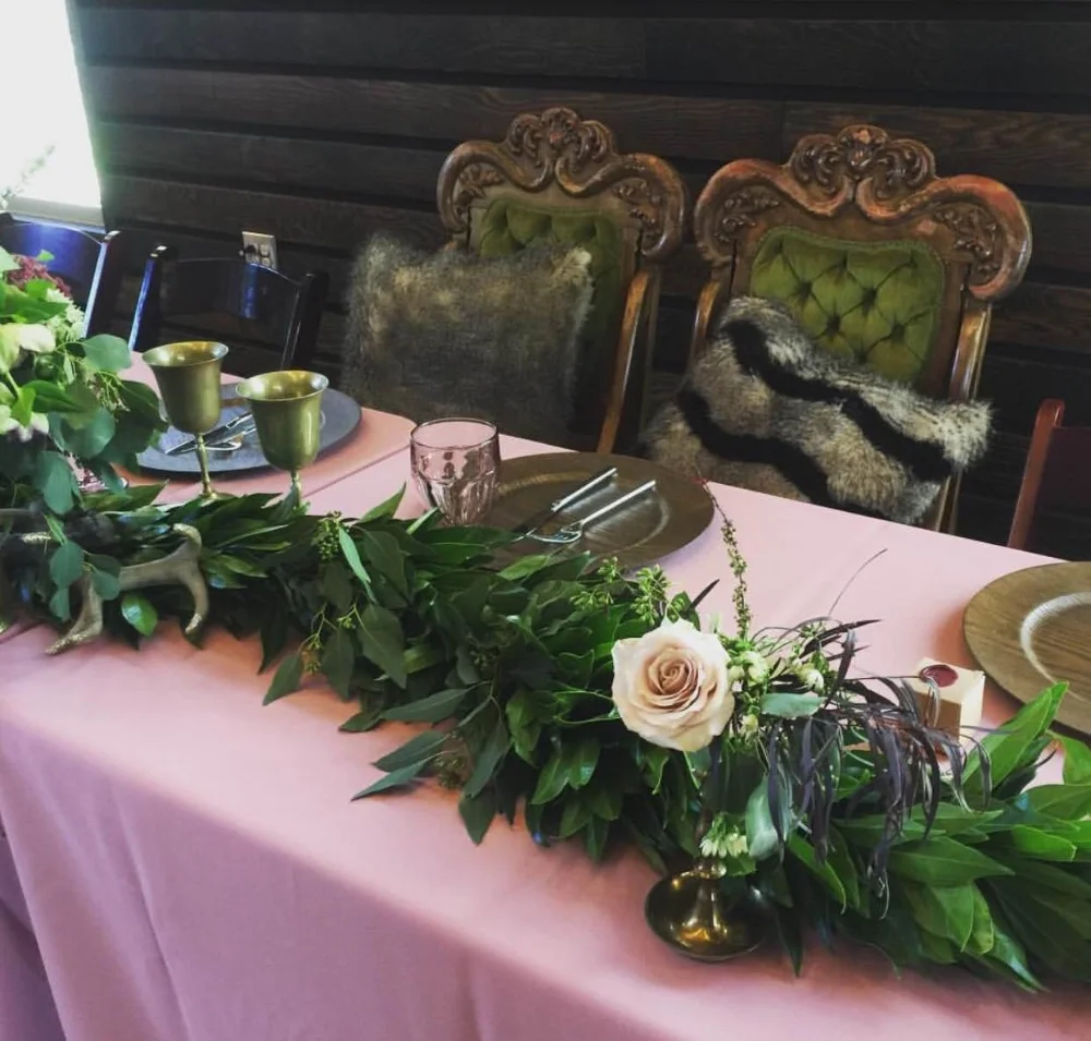 Head Table- Why not sit in throne chairs and drink out of brass goblets?! Oh, and you can't have a royal table without a garland!