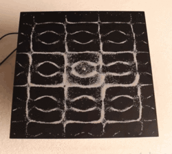 Cymatics visualize frequency by placing crystals on a sound plate.