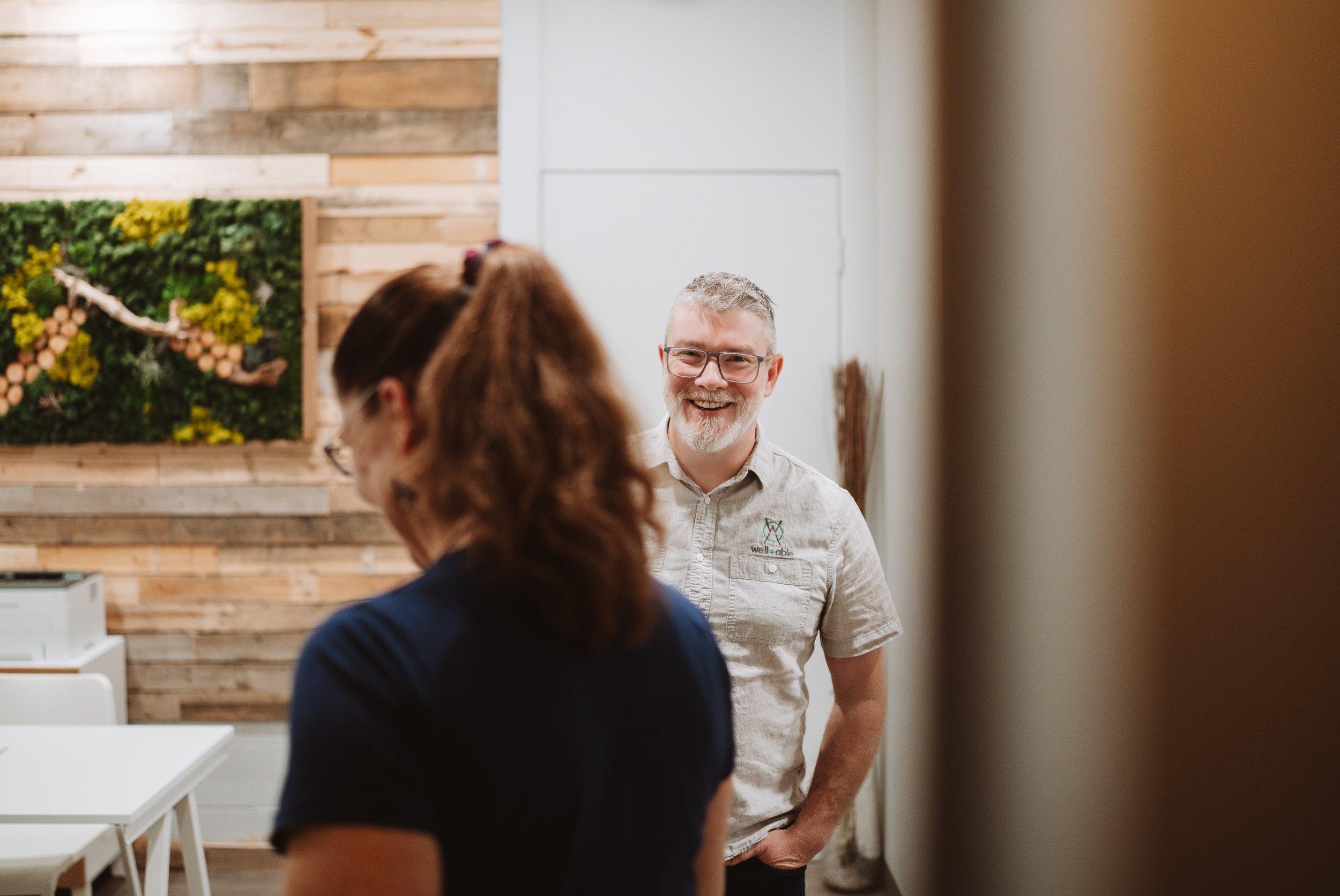 Mike Reoch, RMT greeting a patient at Well+Able