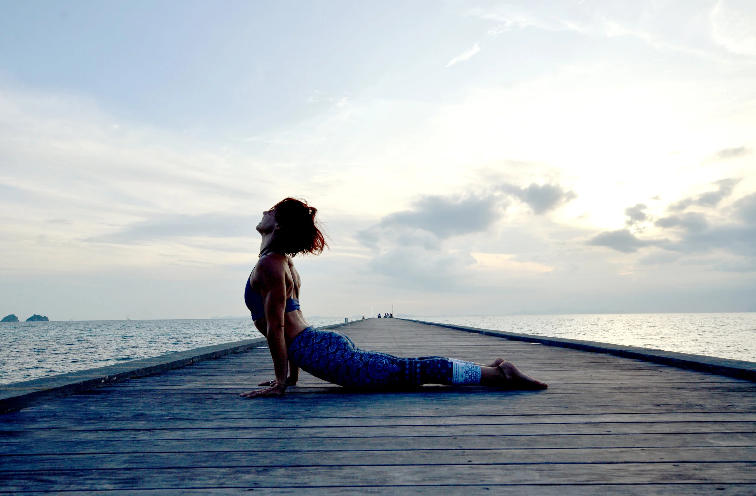 Kerill Ezzy, at a pier in Koh Samui, Thailand. She is dynamic powerhouse who trains with great passion and rigour. She will challenge you to the depths of your toes. Currently teaching in Macau, running workshops in Asia and soon Australia. Check her out: http://kerillyoga.com/