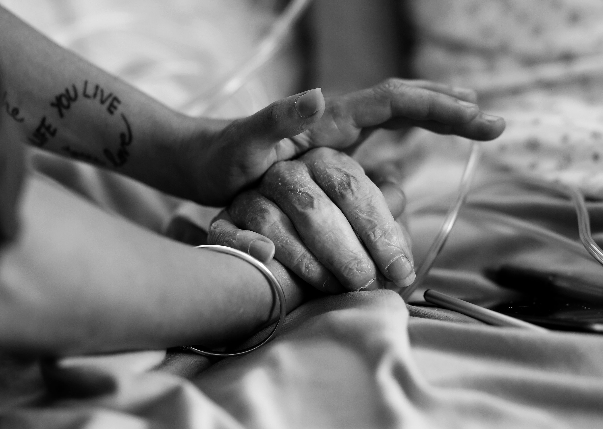  PJ McGrath's daughter comforts her dad as Dr. H administers medication during his assisted death in his hospital room. 