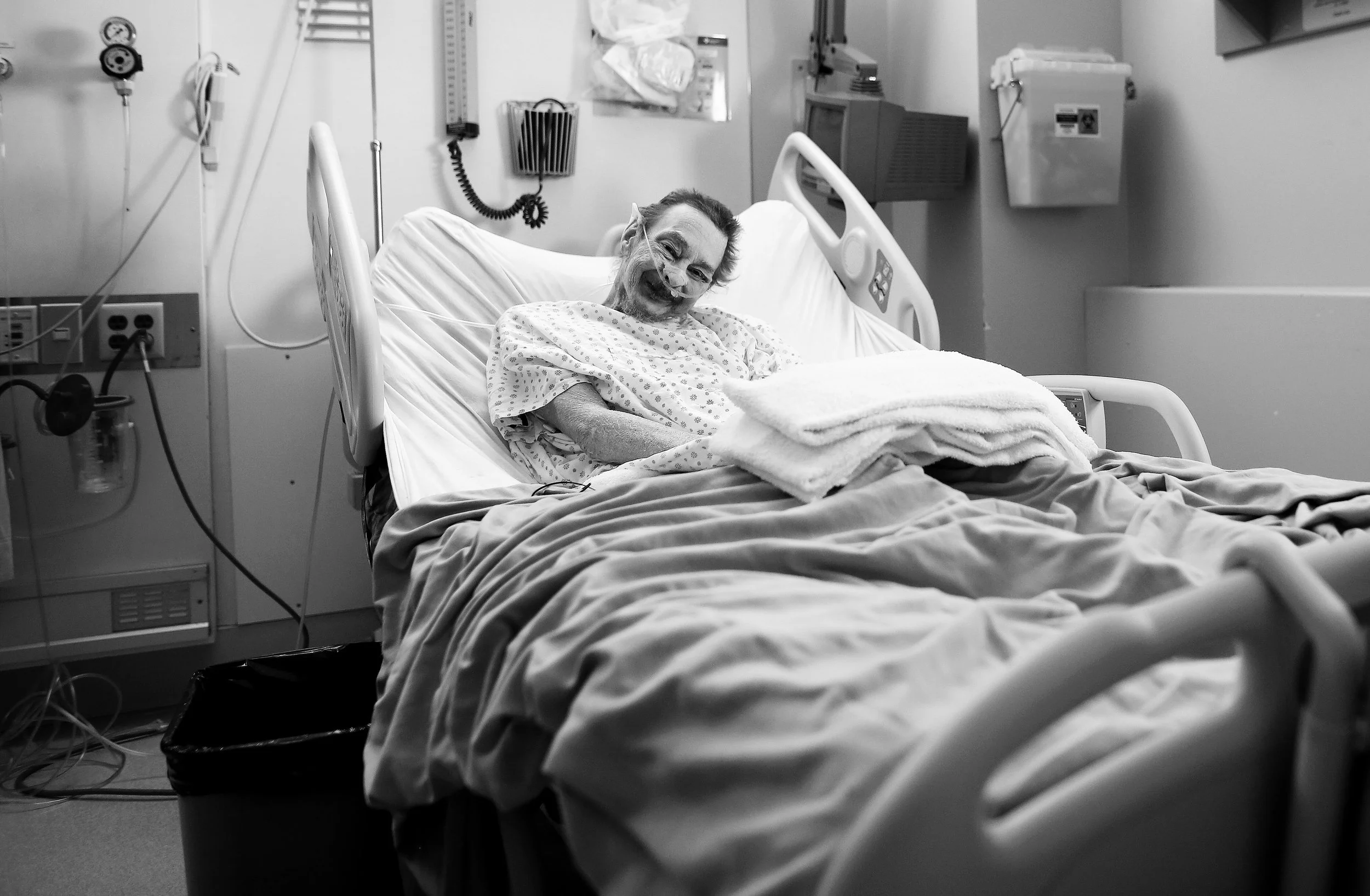 PJ McGrath is his hospital room where he has been for the last 10 months. His back and bony knees propped up as much the bed allowes, his head was frozen in this awkward pose — the end result of cancer and the radiation used to treat it. 