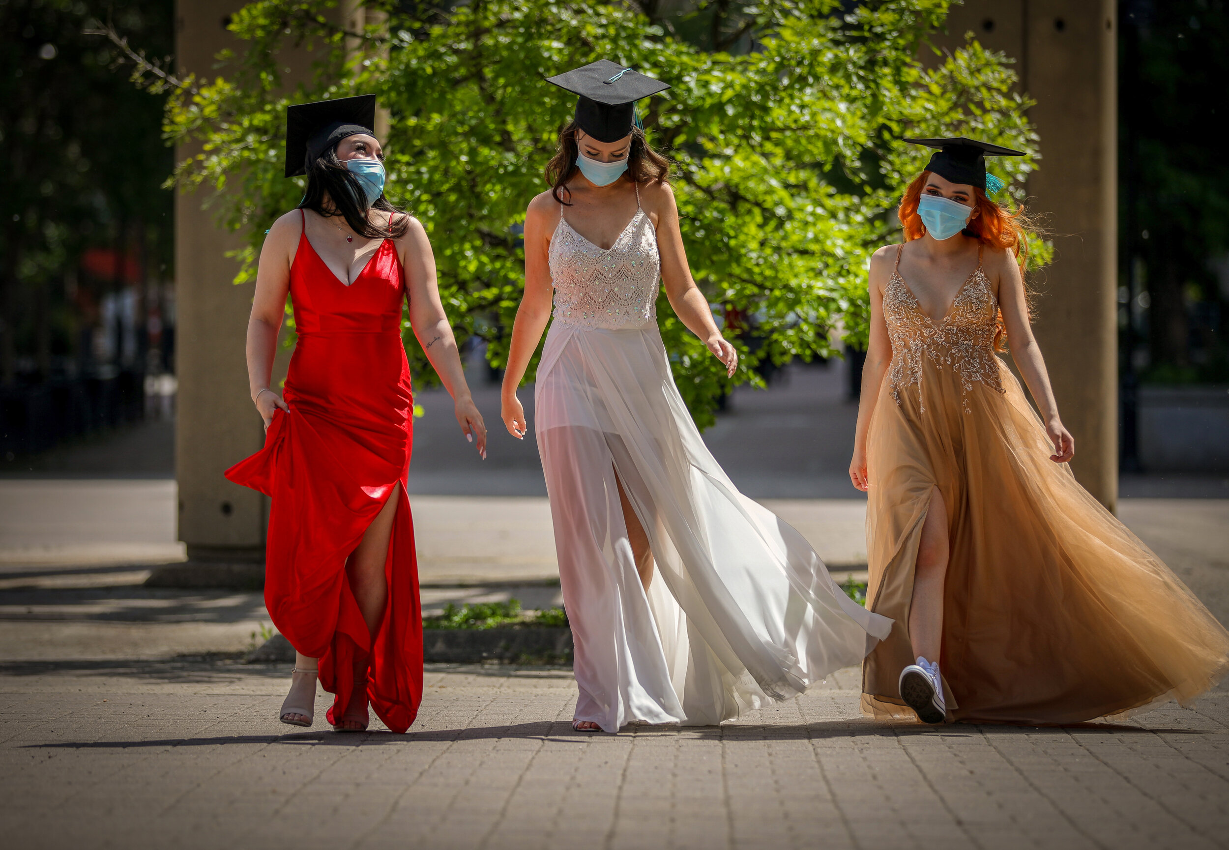  Lauren Desousa, Teresa Blach and Linda Flores, Grade 12 grads from Bishop McNally, take a walk in Calgary during a socially distanced photoshoot. 