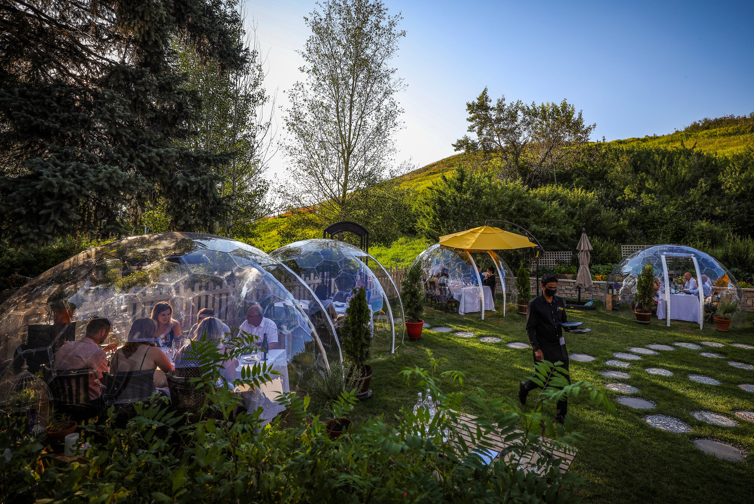  On a day when Alberta recorded 513 new cases of COVID-19, patrons enjoy a meal inside pop-up garden globes at Bow Valley Ranche Restaurant in Calgary, Alberta. 