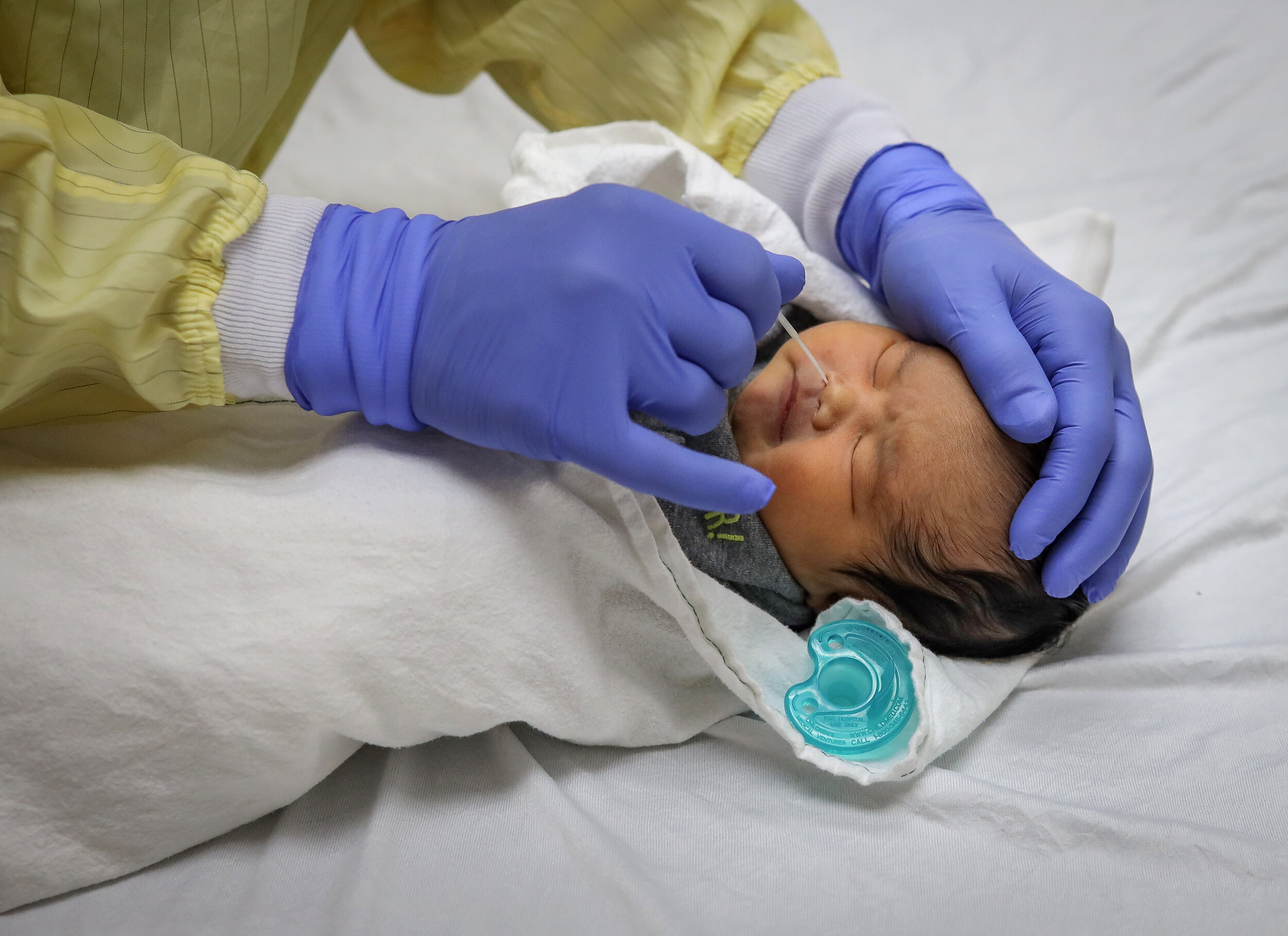  Dr. Stephen Freedman, a pediatric emergency medicine physician, gives a COVID-19 swab to a five-day-old baby boy at the Alberta Children’s Hospital in Calgary, Alberta, on August 14, 2020. 