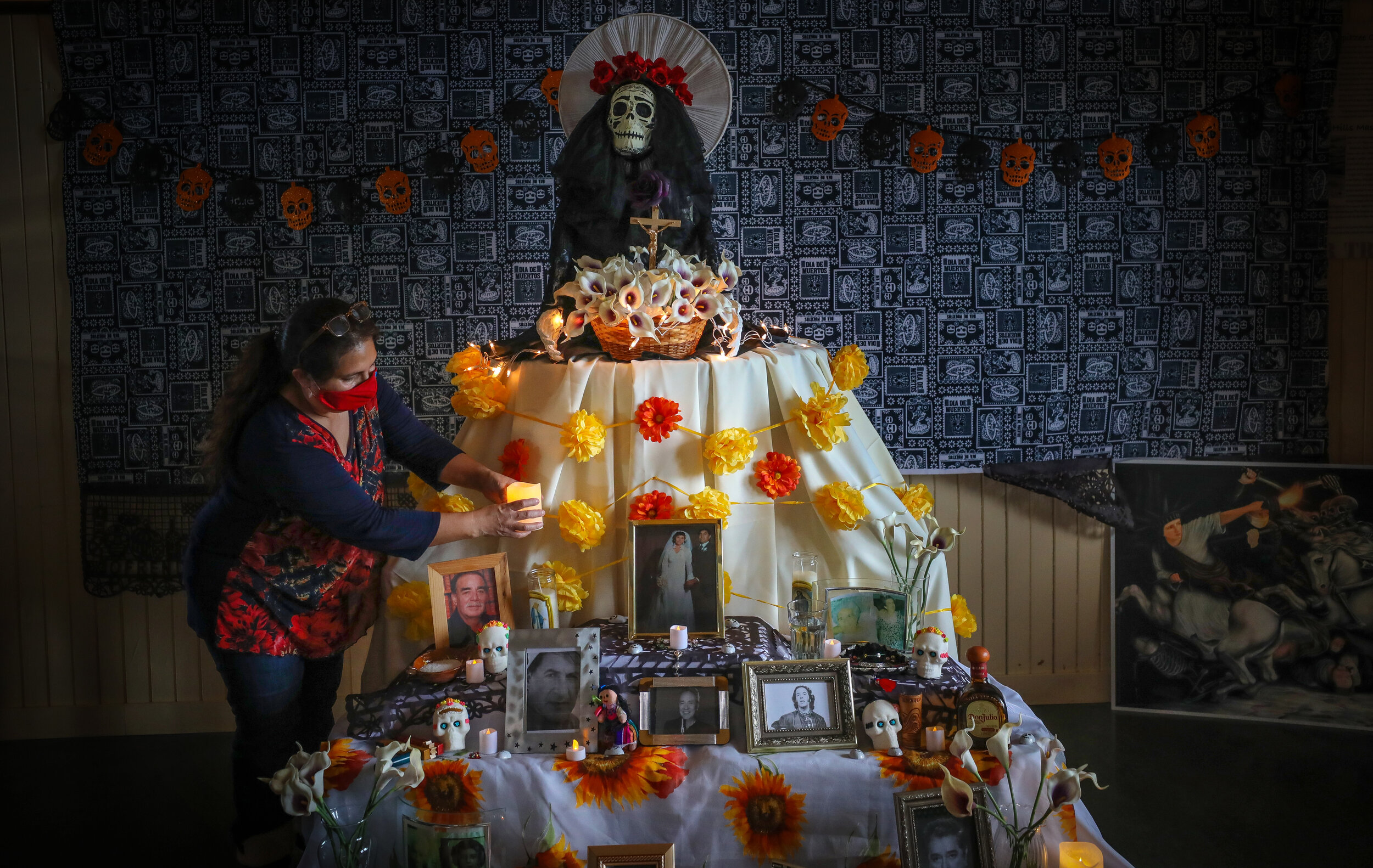  Liz Vigueras finishes the altar at the Highwood Museum in High River, Alberta, for Day of the Dead celebrations. This year the altar is also remembering those who have died from COVID-19. 