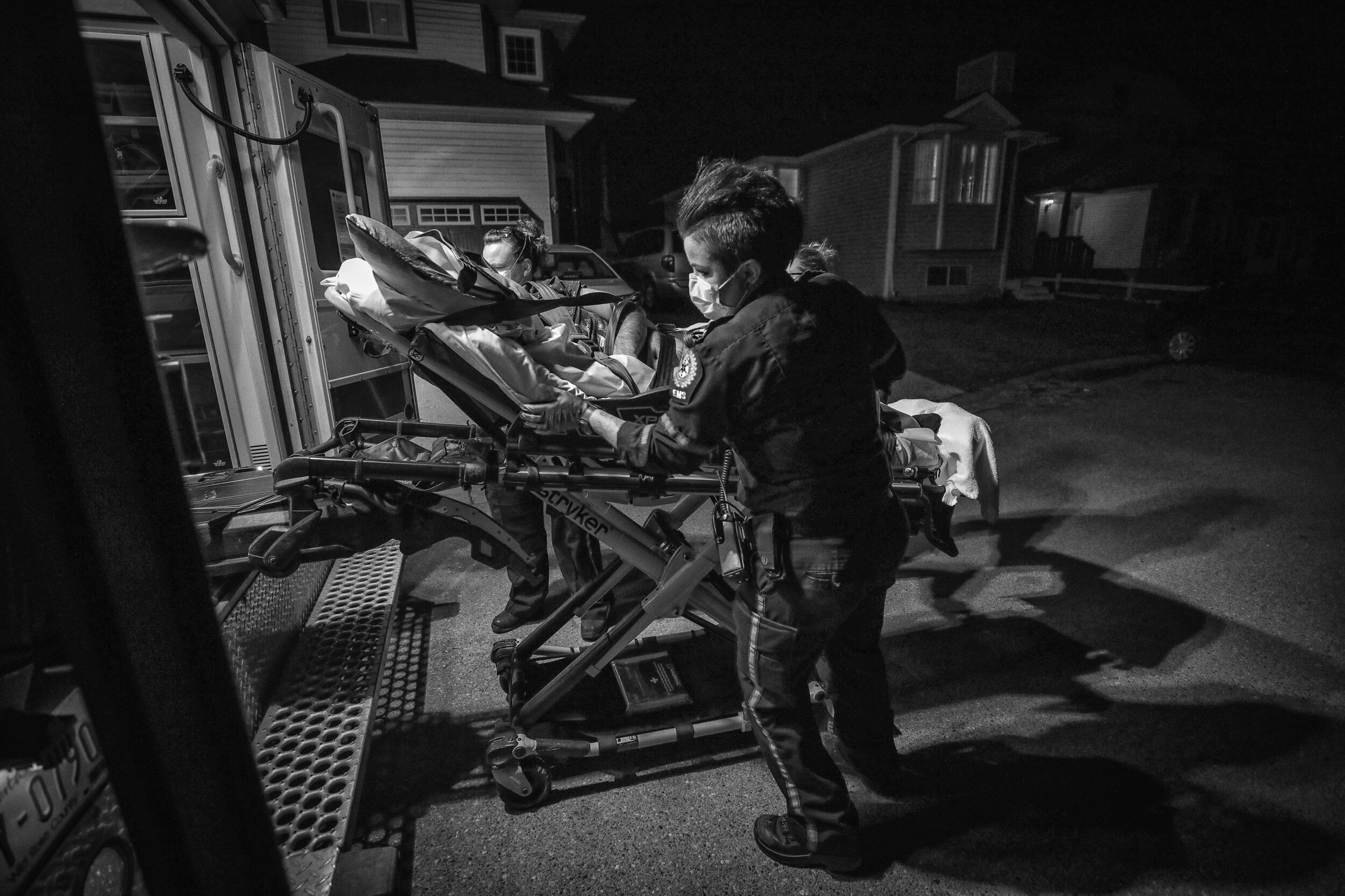  During a summertime night shift, paramedics transport a patient to hospital in Calgary, Alberta. 