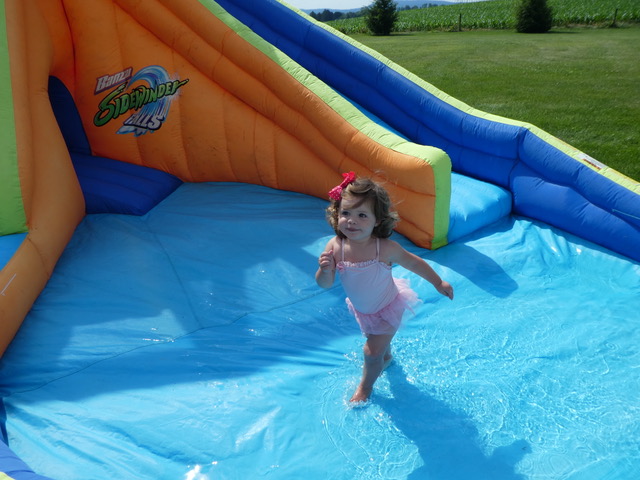 Rachel cools off in the backyard blow-up pool center.