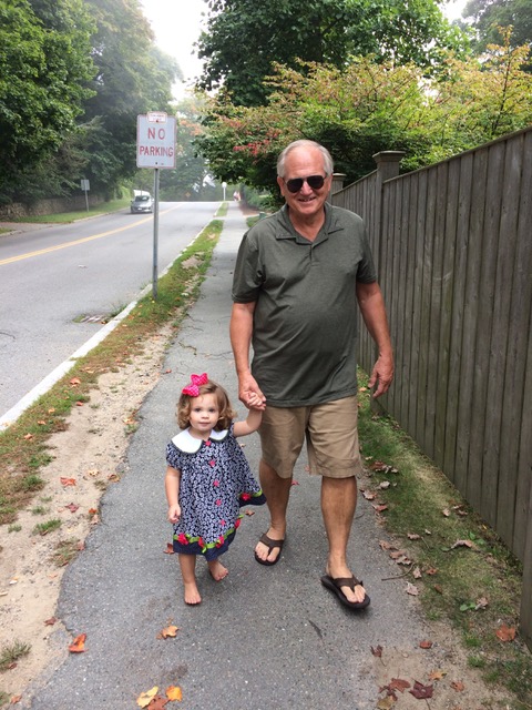 Papa and Rachel walk back to the car from the beach. Not sure when her shoes came off, but she enjoyed the barefoot walk.
