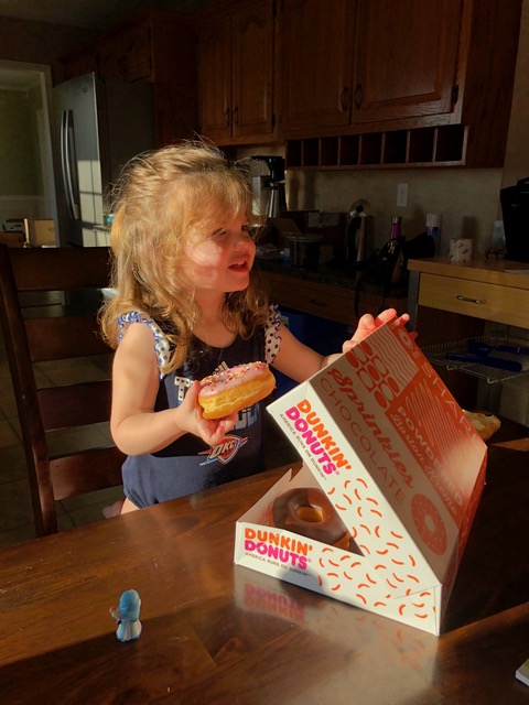 Rachel’s love for pink frosted donuts is met when Uncle David and Aunt Laura arrived on moving day to support the effort.